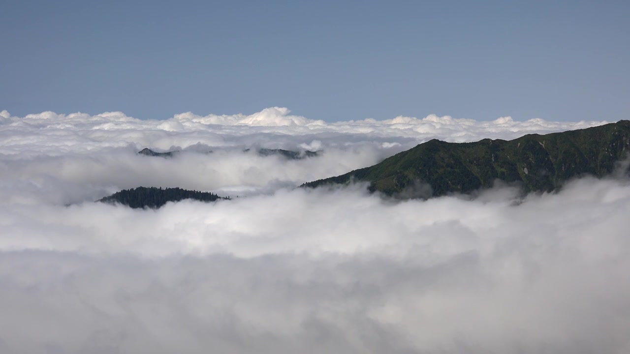 Mountain Peaks Rising Above a Thick Sea of Clouds