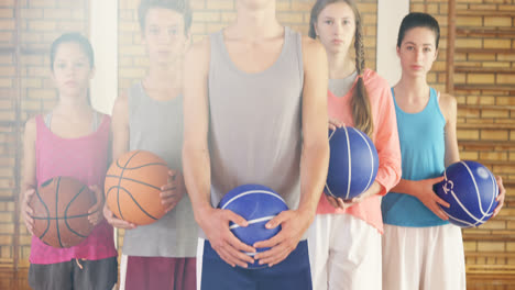 high school kids with basketball standing together in basketball court