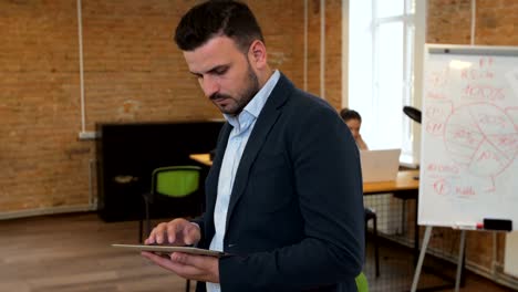 man using black tablet with green screen at modern office. camera stabilizer shot.