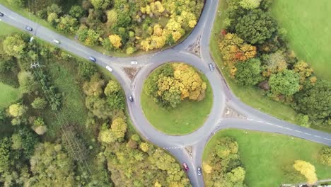 aerial view rotating over roundabout infrastructure traffic vehicles from above