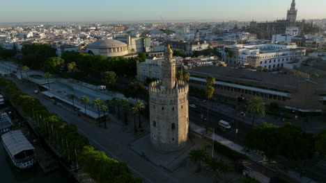 Torre-del-Oro-Along-The-Guadalquivir-River-In-Seville,-Spain---aerial-drone-shot