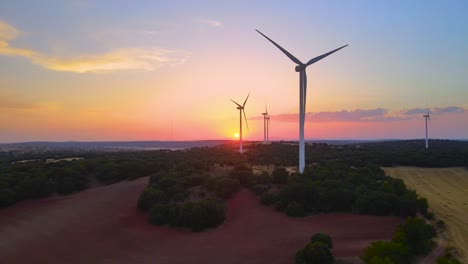 Wind-turbines-farm-silhouettes-with-beautiful-golden-hour-evening-Sun