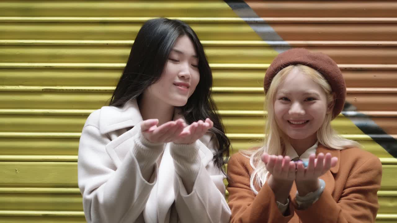 Two friends celebrating with confetti