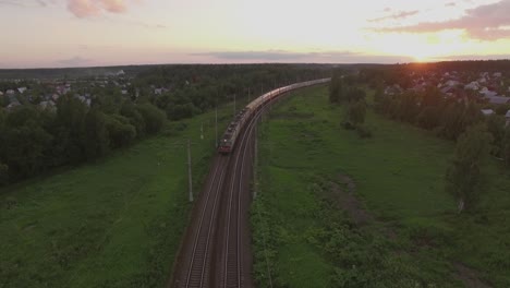 cargo train crossing countryside at sunset russia