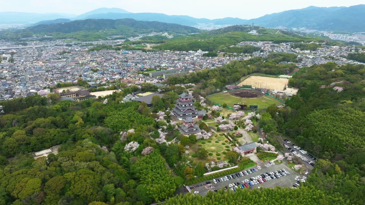 Drone fly Kyoto's famous Fushimi Momoyama Castle, Aerial view of Japan in Spring with cherry blossom Sakura