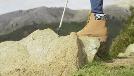 Person-in-hiking-boots-in-the-mountains