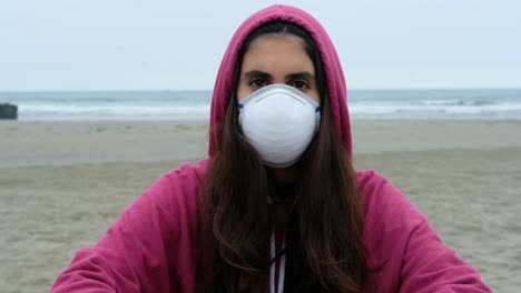 portrait of casual brunette young woman with protective medical face mask