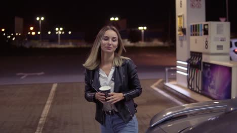 Attractive-Young-Woman-Open-The-Car-Door-While-Holding-A-Cup-Of-Coffee-And-Sits-On-A-Passenger-Seat