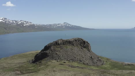 aerial of volcanic tuya on small holmanes peninsula at reyðarfjörður fjord