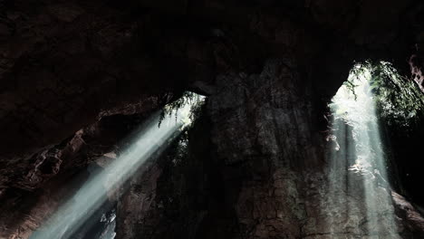 sunbeams shining into a dark cave