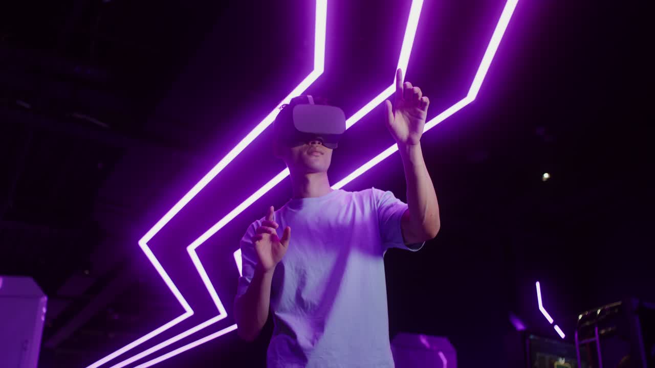 Man using VR headset with purple lighting