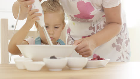 serious pretty little girl concentrating on baking