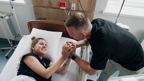 couple supporting a pregnant woman in hospital