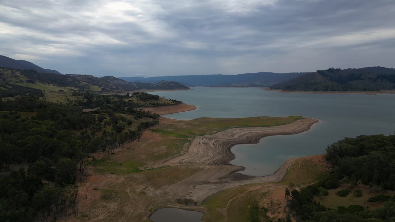 Forward moving aerial view over Blowering Reservoir (dam) near Tumut in the Snowy Mountains Region of New South Wales.