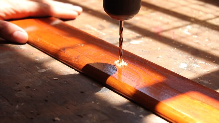 Close Up of a Drill Making a Hole in a Wooden Plank