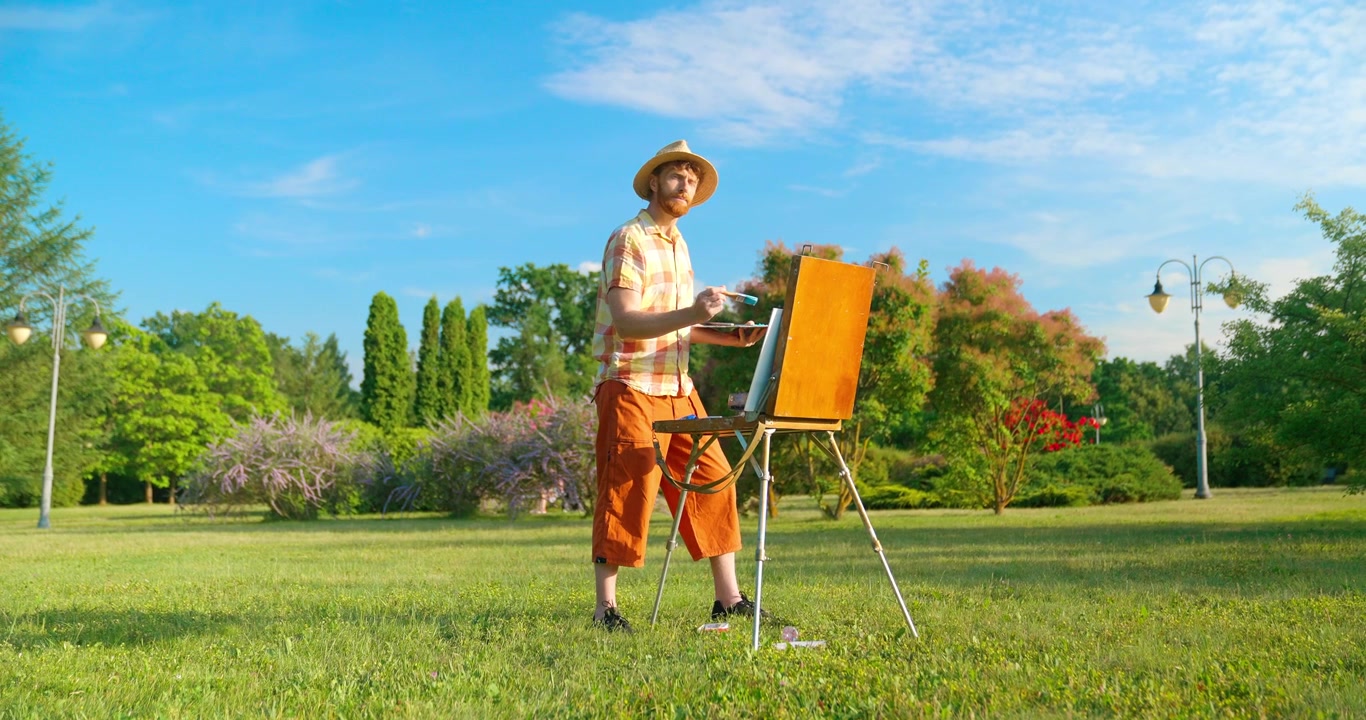Artist Painting on an Easel in a Green Park on a Sunny Day