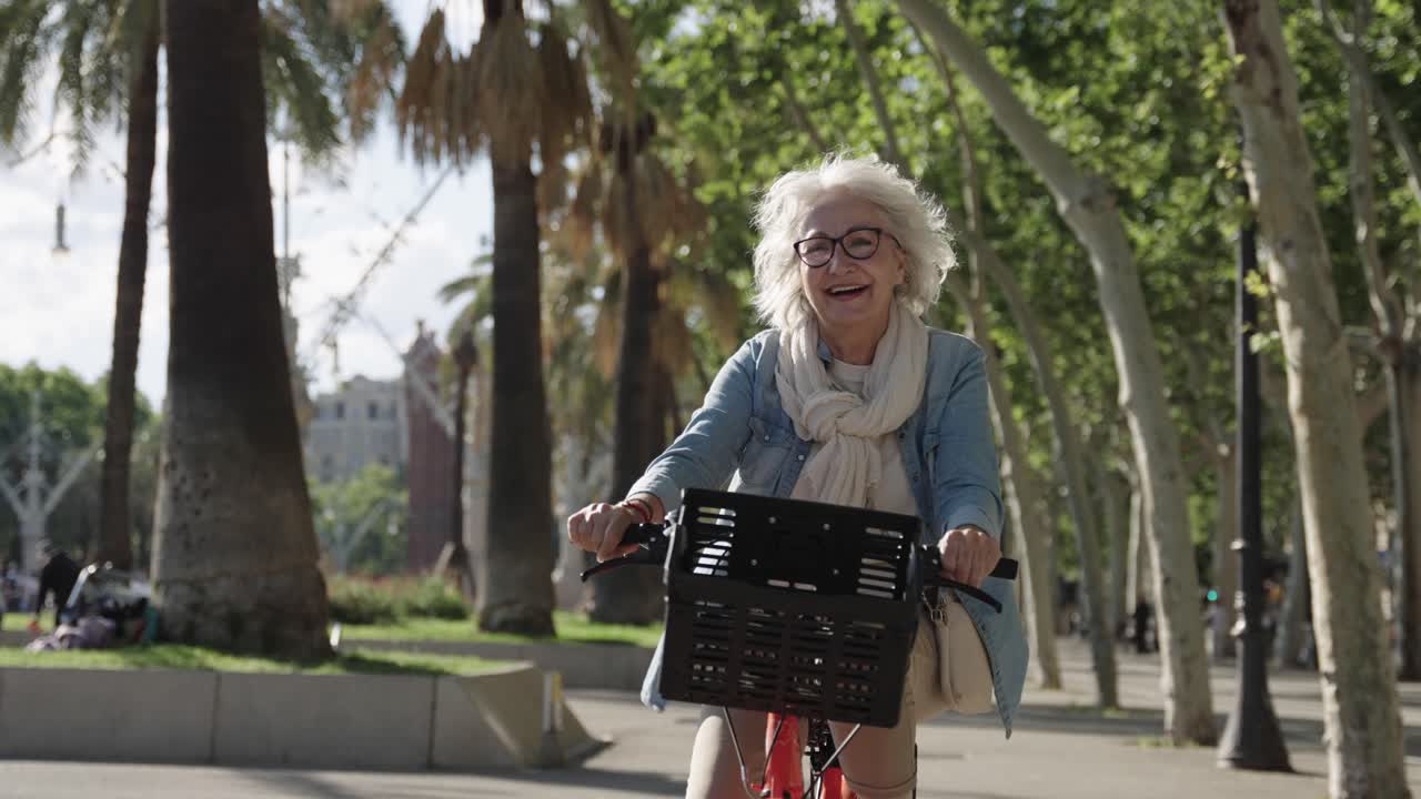 Elderly woman riding a bicycle in a park