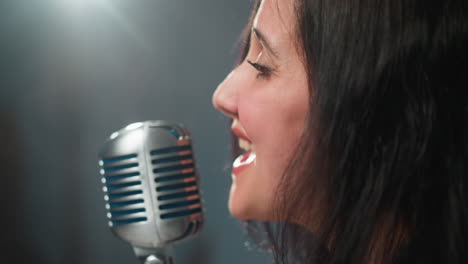 extreme close-up of a female singer passionately singing into a vintage microphone with intense emotion, set against a soft, blurred background