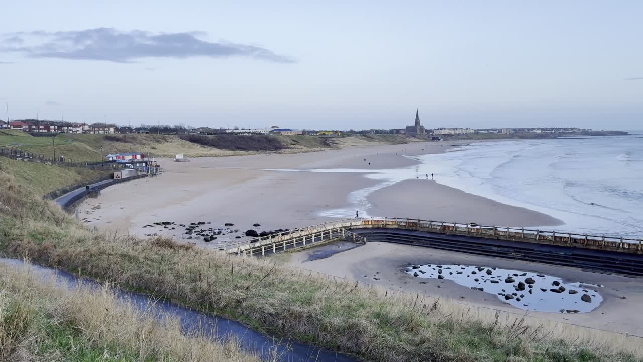 Tynemouth Longsands beach on a quiet spring morning as the sun rises - Tynemouth, North East England, UK