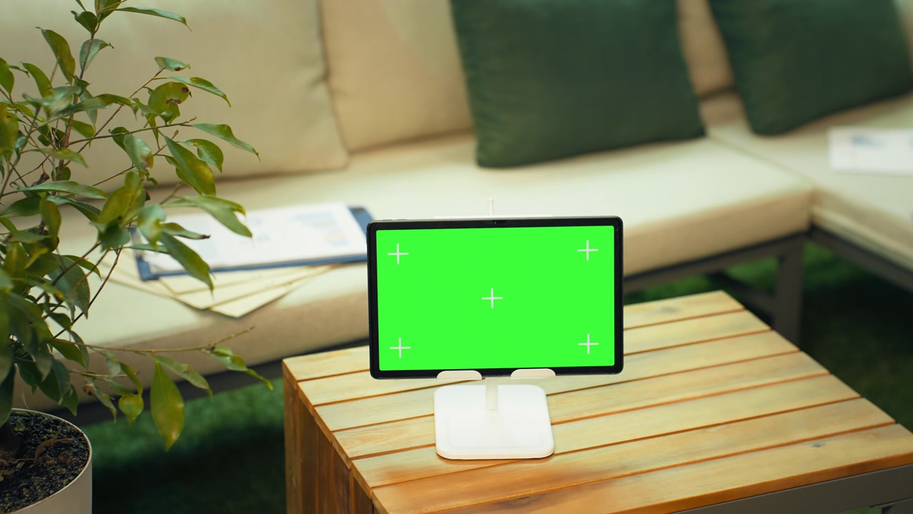 Green screen tablet mockup in rooftop lounge for mobile apps