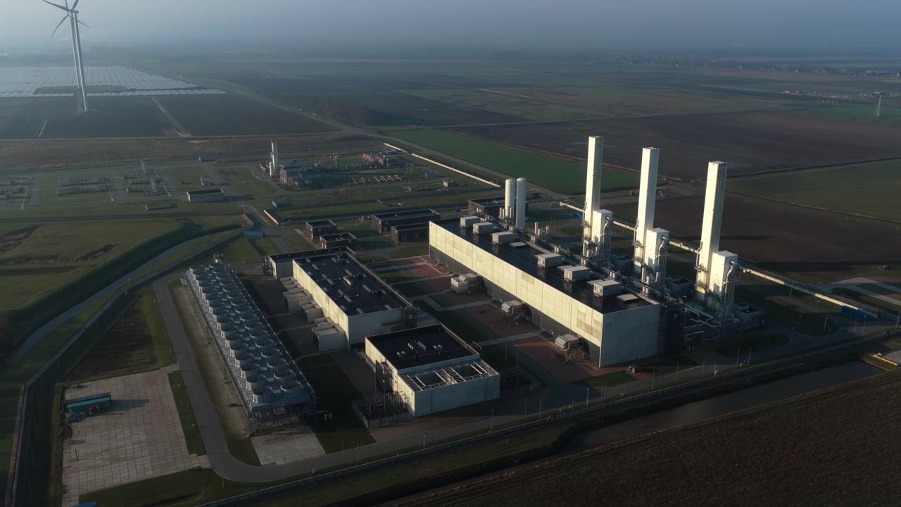 Aerial circling view of the gasunie nitrogen plant in zuidbroek, netherlands, showing the industrial complex and surrounding landscape