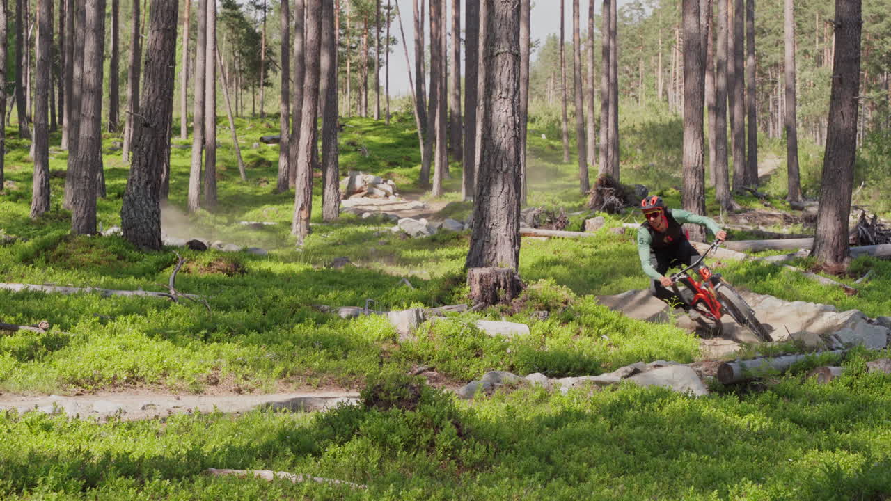 Epic mountain biking adventure above the fjords near Sogndal, Norway. Rider tackles rugged trails surrounded by dramatic cliffs, lush green hills, and stunning Nordic scenery