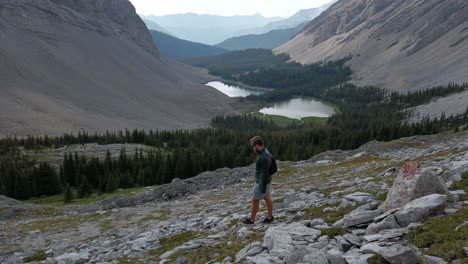 hiker walking down mountain valley rockies kananaskis alberta canada