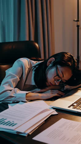 woman asleep on desk after long hours of work