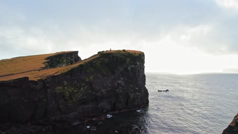 Flying-Over-Terrain-To-Reveal-Epic-Seaside-Cliffs-With-Beautiful-Sunlight-In-Background