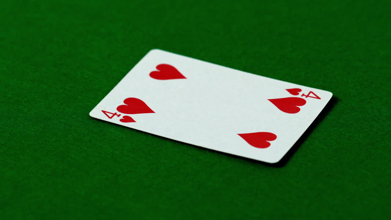 Four of hearts falling on casino table