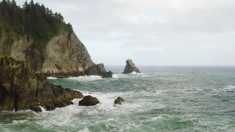 low aerial flight towards sea in rough pacific ocean along oregon coast