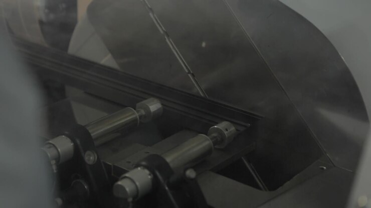Circular Sawing machine sawing aluminum in a Production of aluminium Windows Workshop. Manufacturing of plastic double-glazed windows. Factory for PVC windows and doors production.