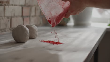 adding red pigment to clay