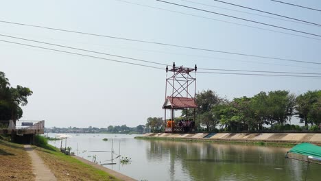 cable car moves over river, transporting passengers