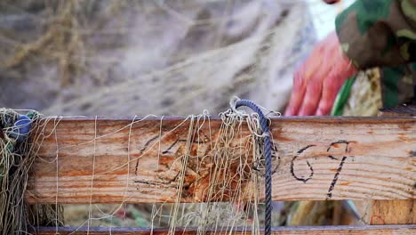 slow motion shot of a fisherman sorting out his hand-casting nets