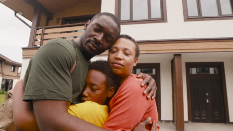 Portrait-Of-Parents-And-Son-Embracing-Each-Other-Outside-Home-Before-Army-Father-Going-To-Military-Service