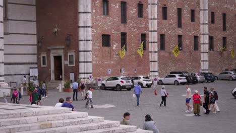 People walking in front of a church in Siena, Italy