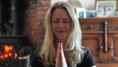 woman meditating with hands in prayer position