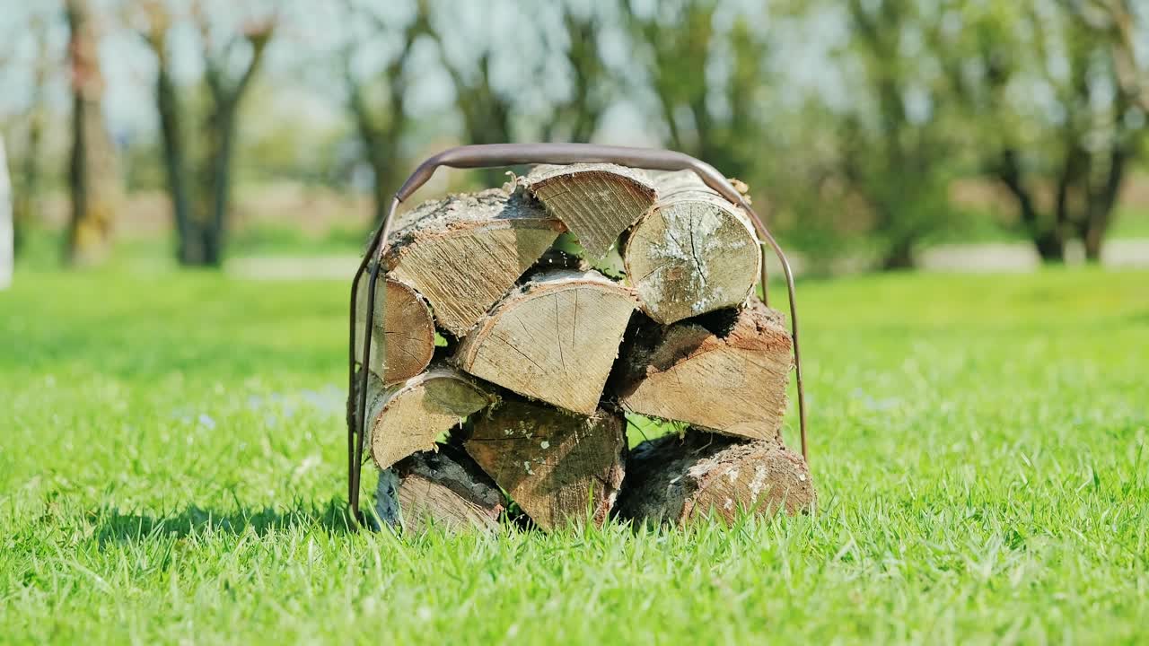 Latvian man in clogs carries wood across grass, evoking rural life, resilience