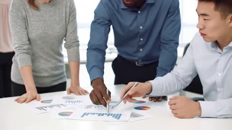 diverse business team analyzing financial charts