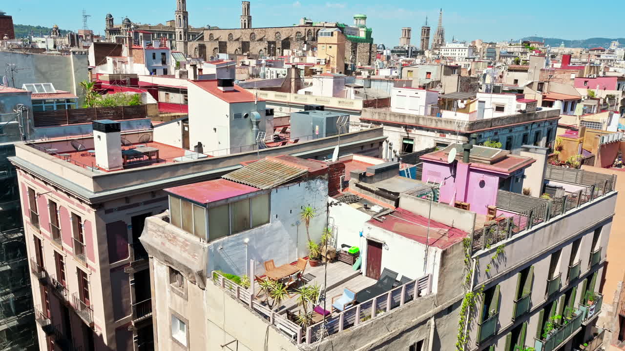 Panoramic view of Barcelona, multiple building's roofs, old cathedrals, Spain