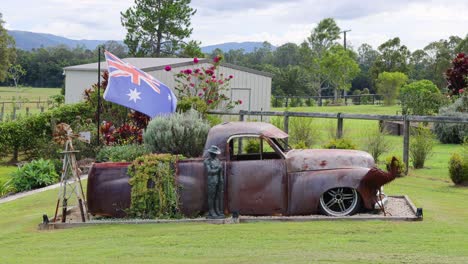 old car and australian flag in rural setting