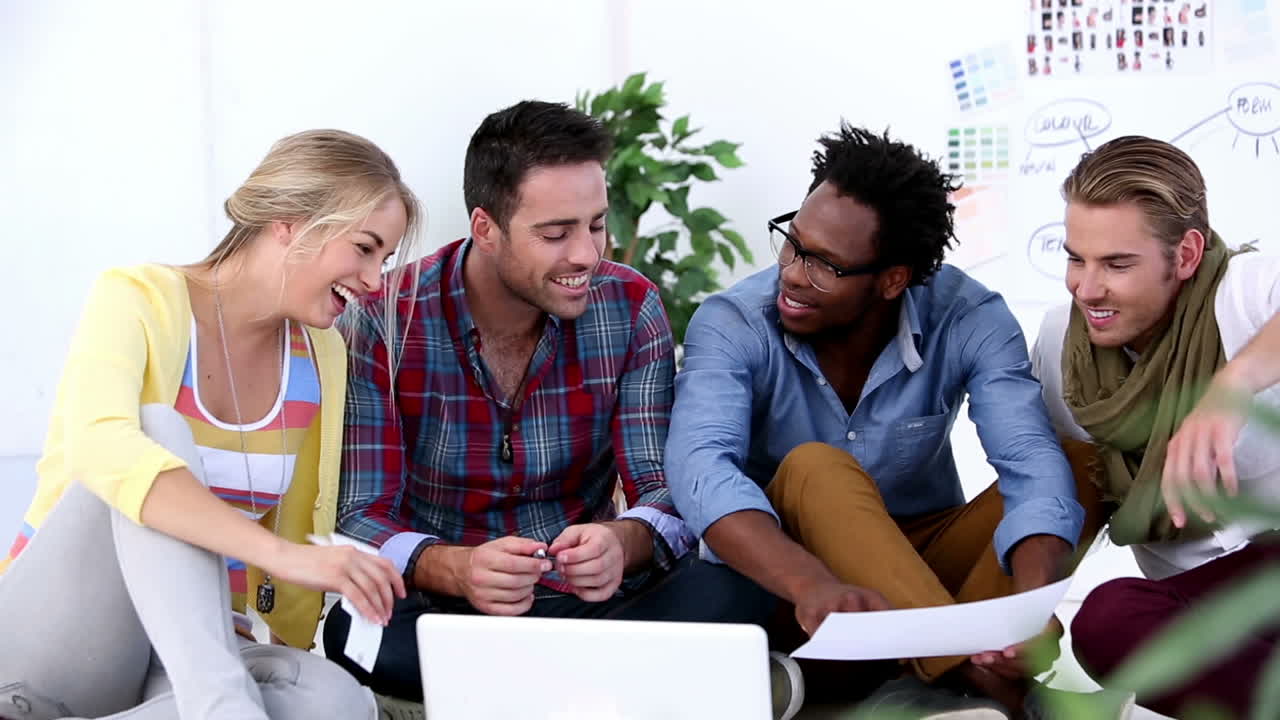 Creative team working together on laptop