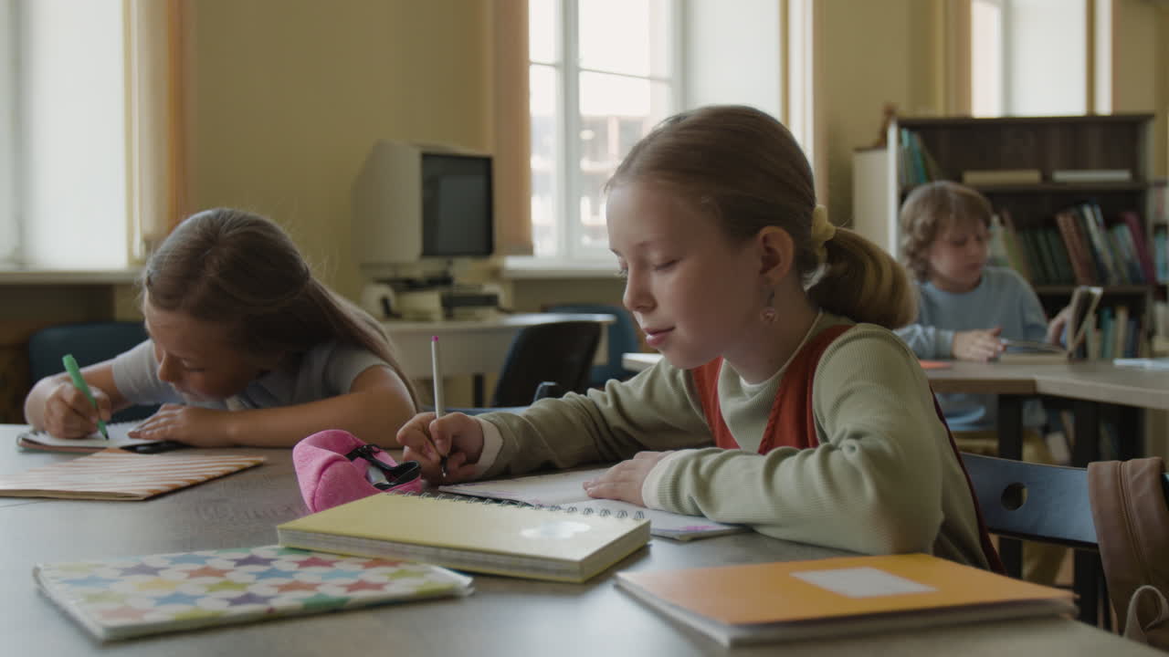 Young students studying and learning in a classroom or library