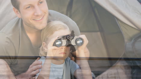 animation of caucasian father and son with binoculars bird watching by tent