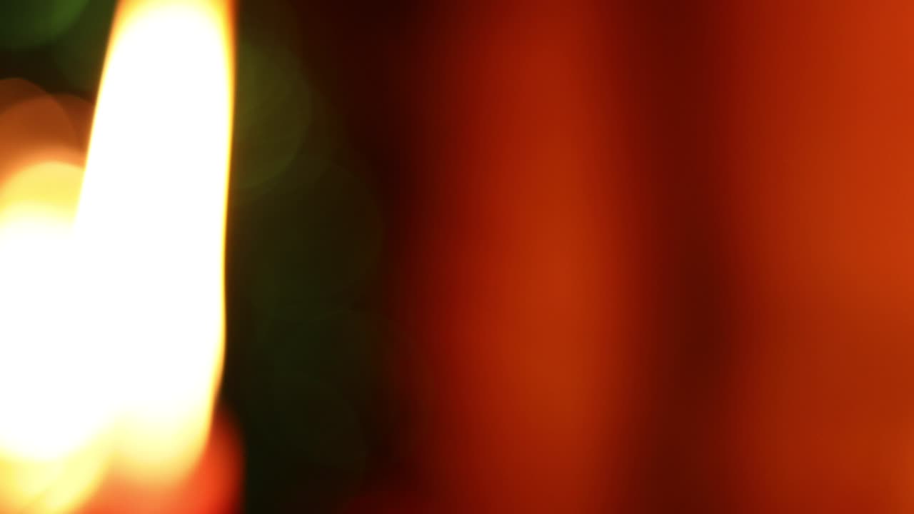 Abstract isolated blurred Christmas lights bokeh background in 4k. Christmas decorations with candle. Left panning shot