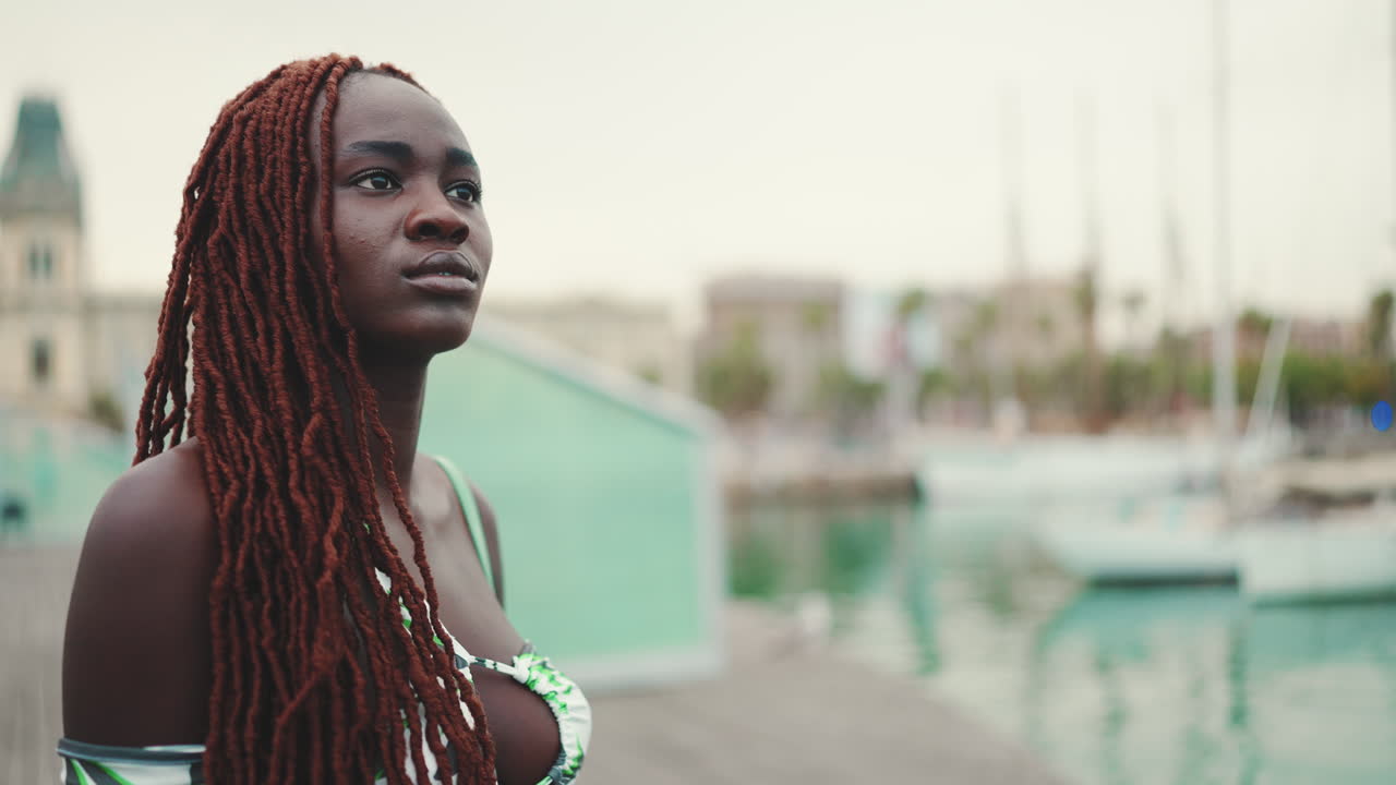 Woman with dreadlocks in a port city