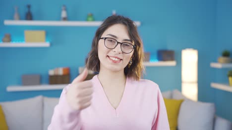 Positive-young-woman-looking-at-camera-making-okay-sign.