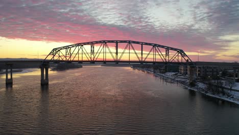 winter sunset over a river with bridge