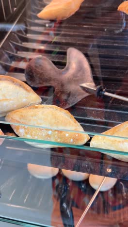 freshly baked bread loaves in a bakery display case
